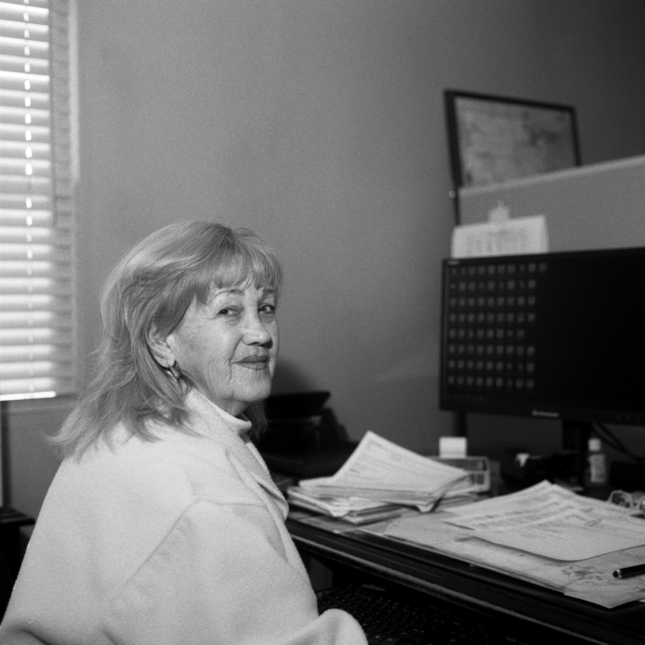 Photo of Lynelda Cypher of Stroud National Agency, Inc. at her desk. © 2023 Mike Garretson. All rights reserved.