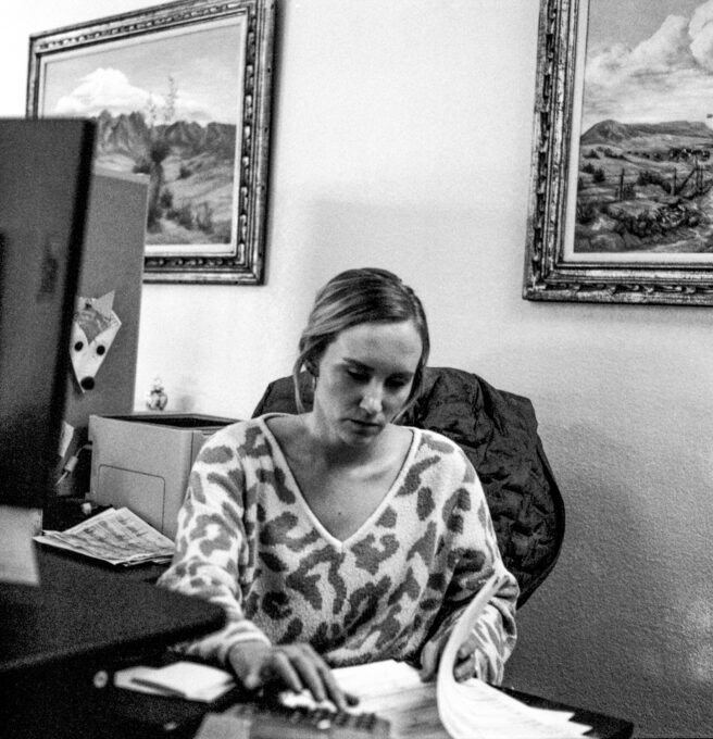 Photo of Dawnielle Cunningham of Stroud National Agency Inc. working at her desk. © 2023 Mike Garretson. All rights reserved.