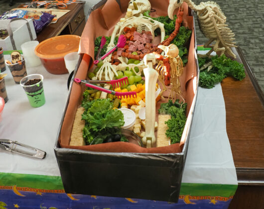 2023 Stroud National Agency, Inc. Halloween Feast - Straight view of food tray inside of a coffin with a skeleton